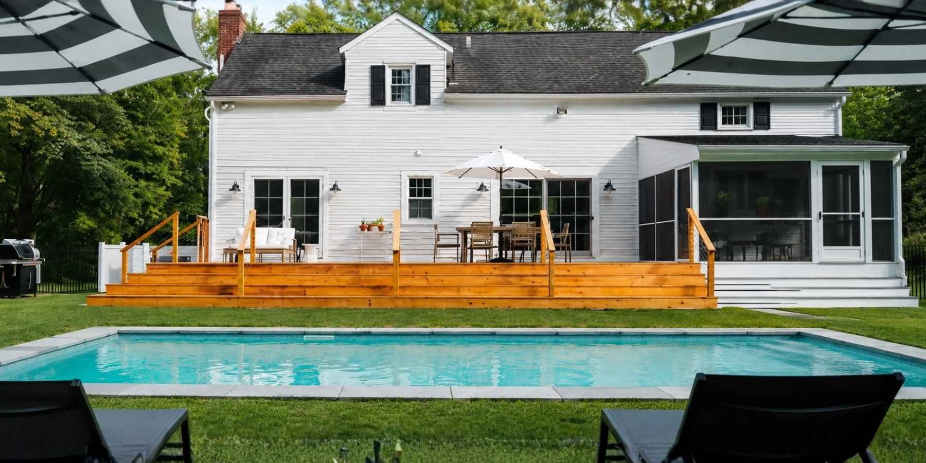 Well-maintained luxury home featuring a backyard pool and landscaped outdoor living space