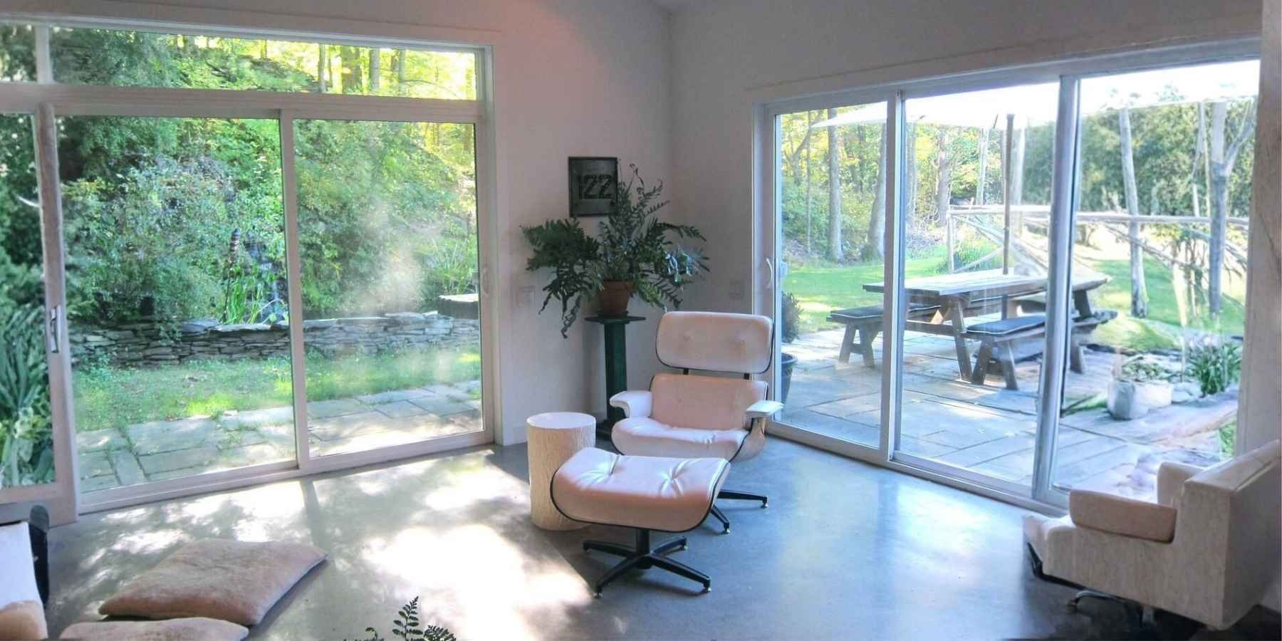 Private outdoor living area with pool views and shaded patio seating